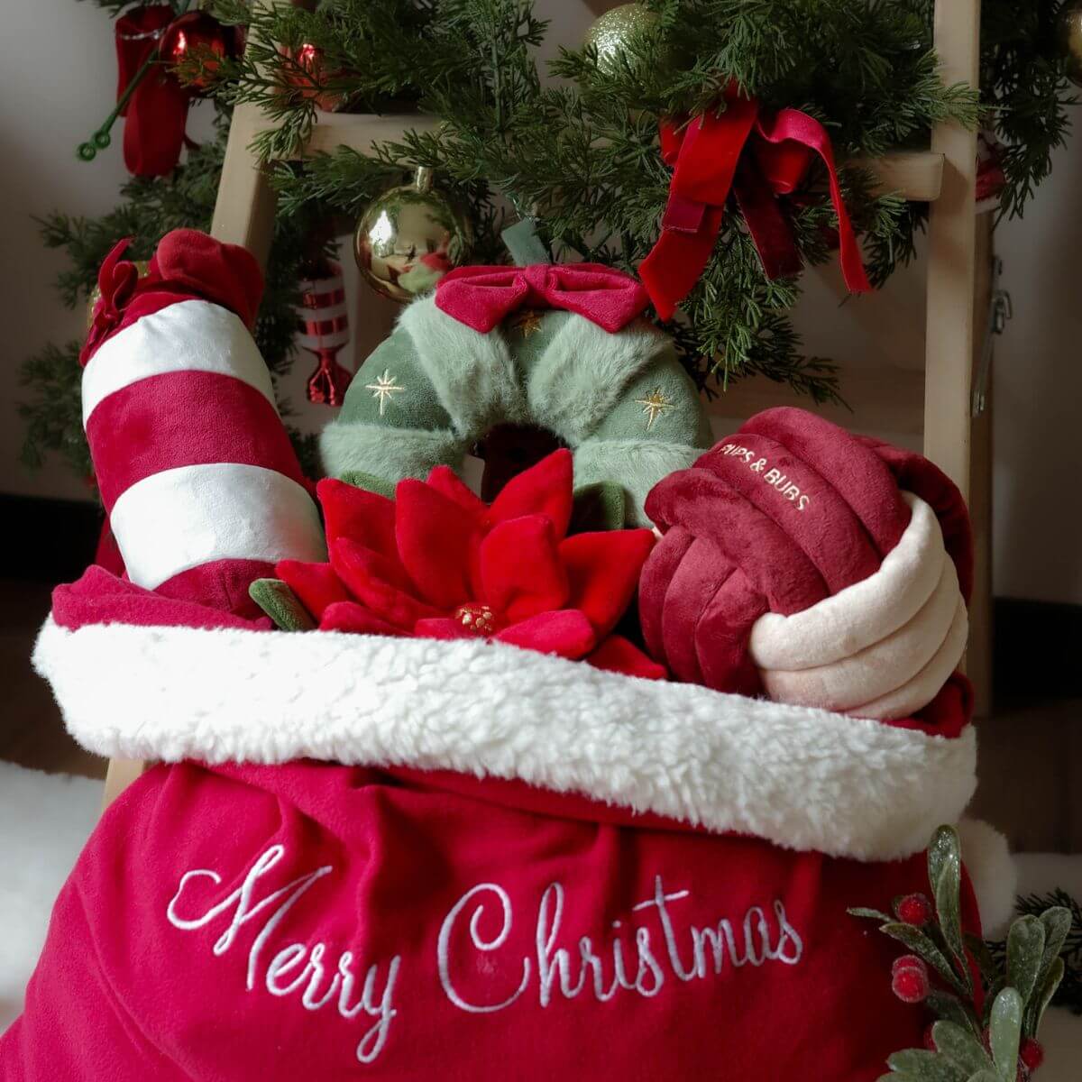 Santa's bag filled with Pups and Bubs' nosework toys including the Pups and Bubs Jingle Know Nosework Toy.