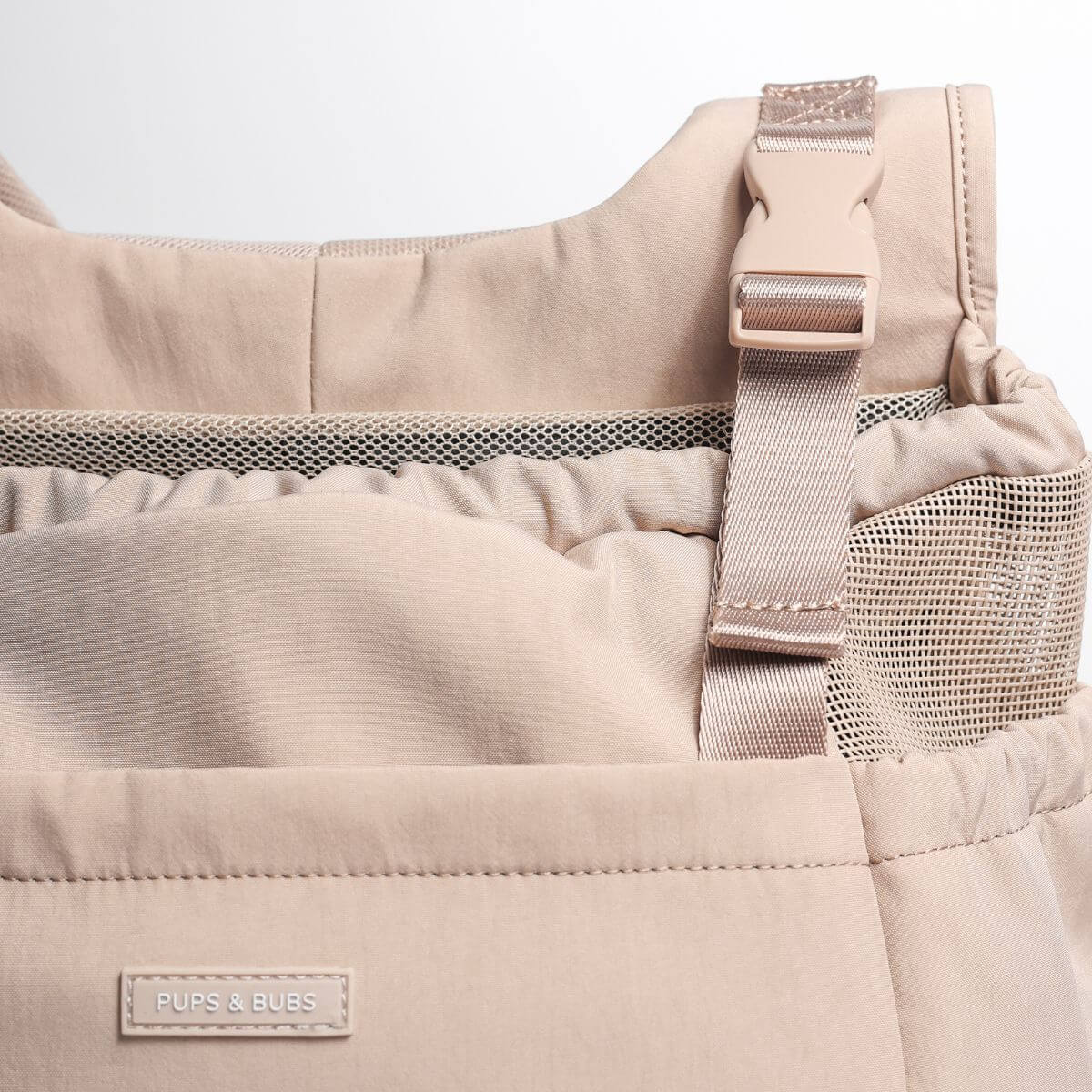 Pups and Bubs Let's Adventure Backpack in Desert against a white background.