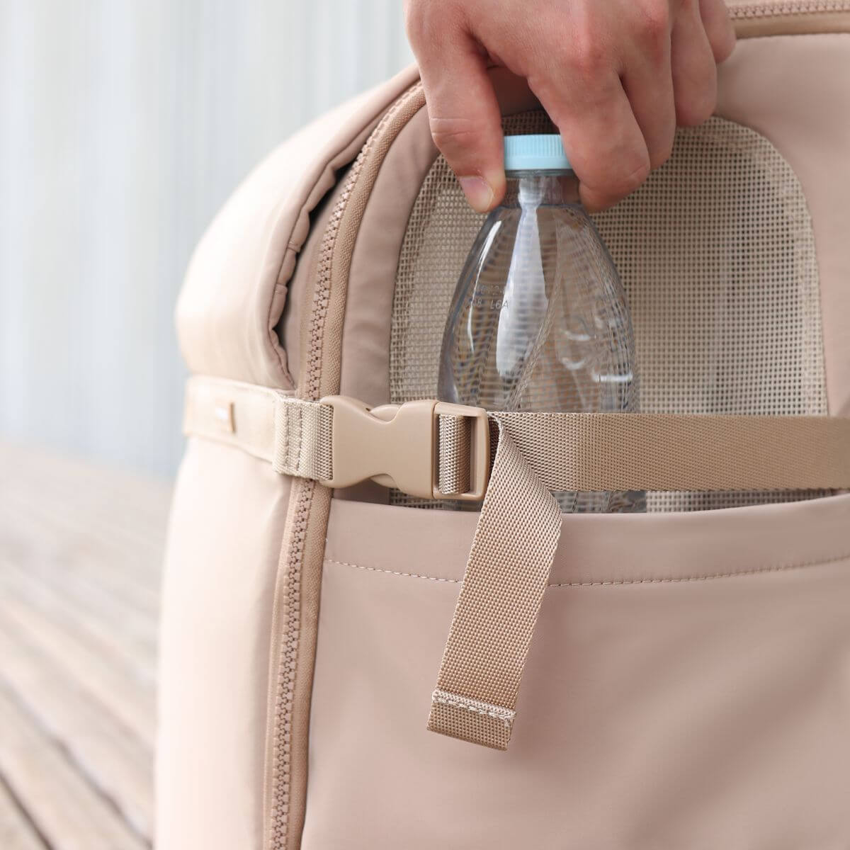 Bottle compartment in the Pups and Bubs Travelers Backpack in Desert.