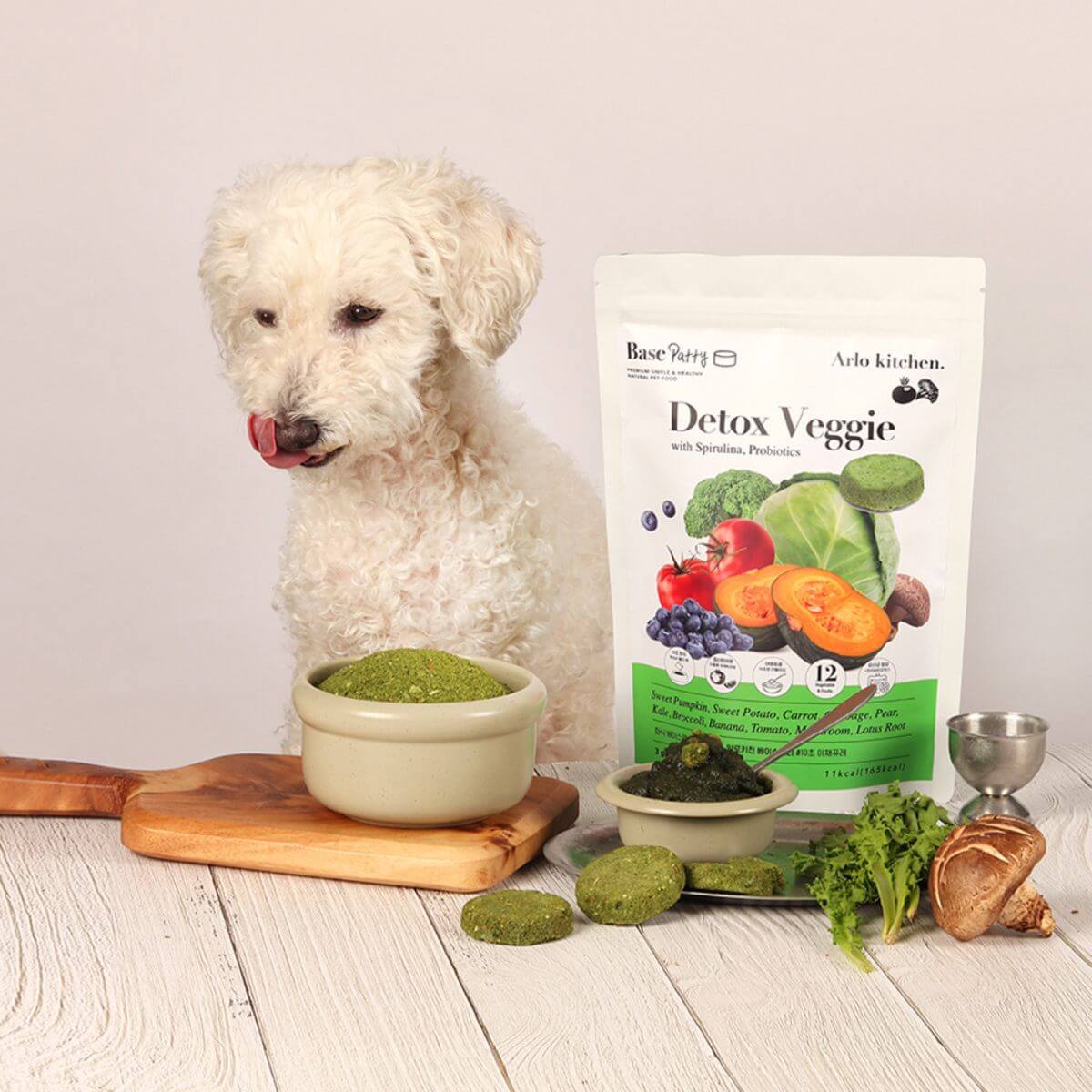 A poodle posing with the Arlo Kitchen Detox Veggie Patties.