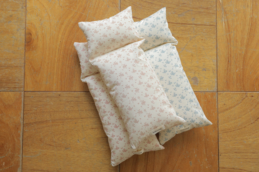 Three fabric bags with floral patterns on a wooden floor