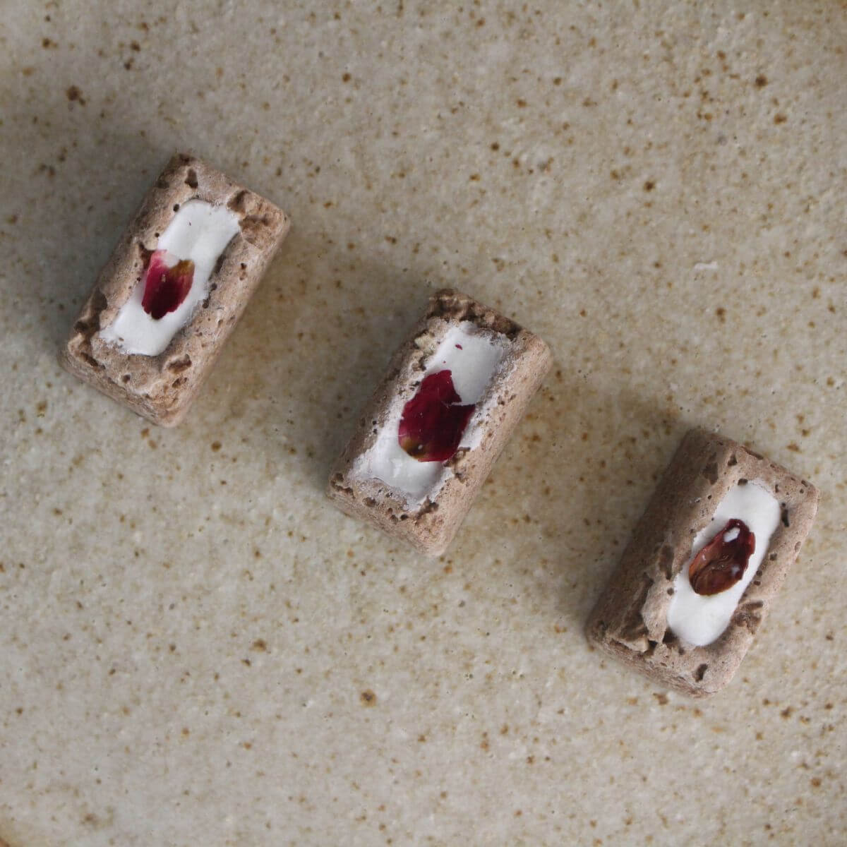 In Good Thyme Pork Liver Praline Regular on a plate - three in a row.