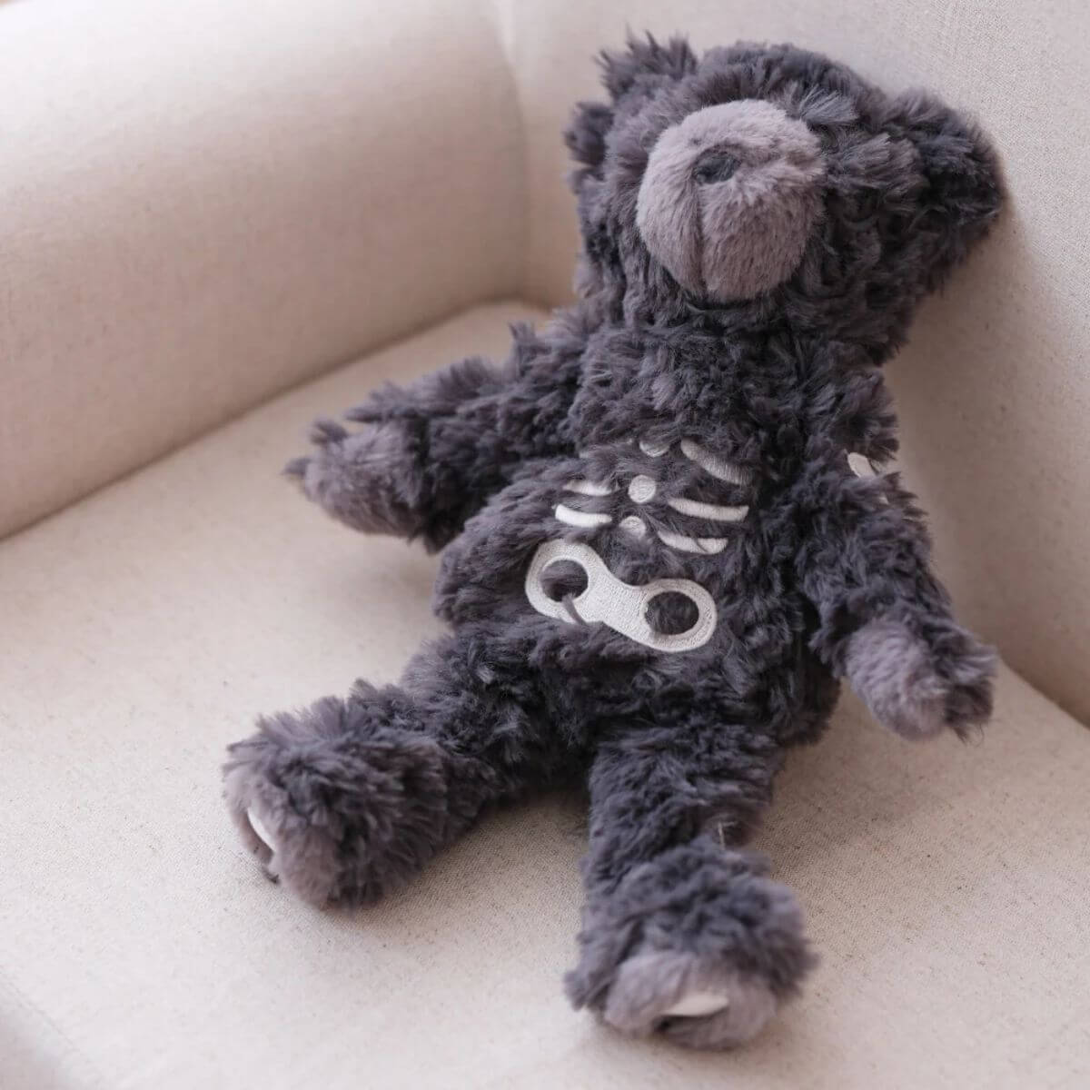lambwolf skeleton teddy on a sofa