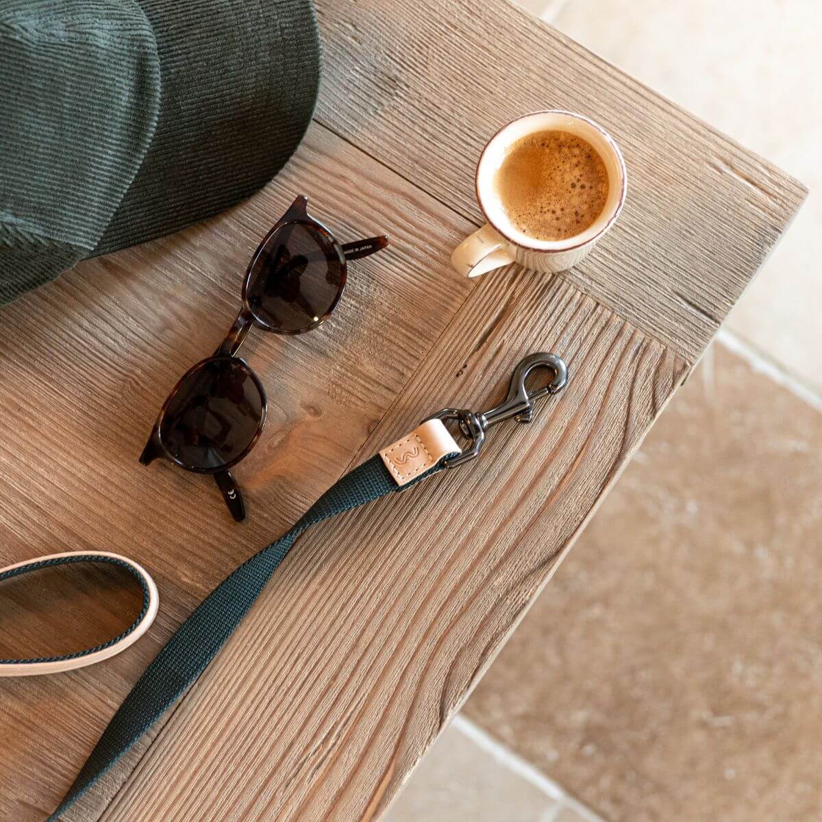 Masimalo Lead in Natural / Pine on a wood table amidst daily essentials.