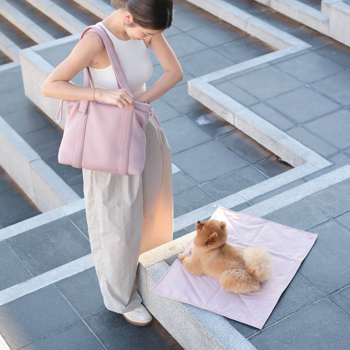 Pups & Bubs Jouir Travel Mat in Rose outdoors.