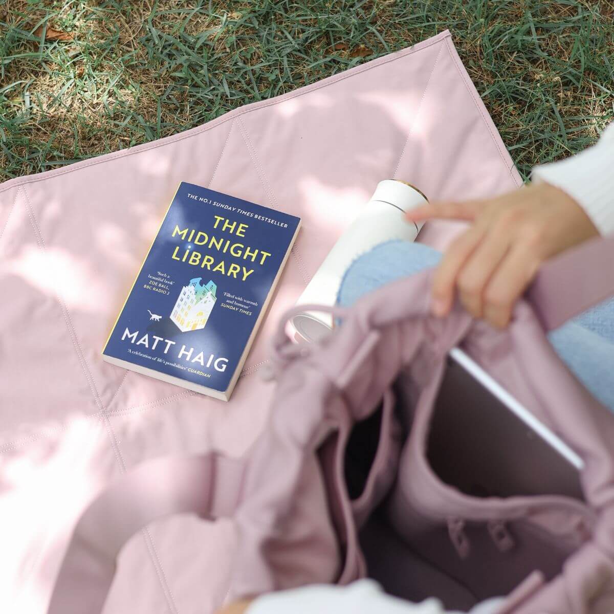 Pups & Bubs Jouir Travel Mat in Rose outdoors as a picnic mat.