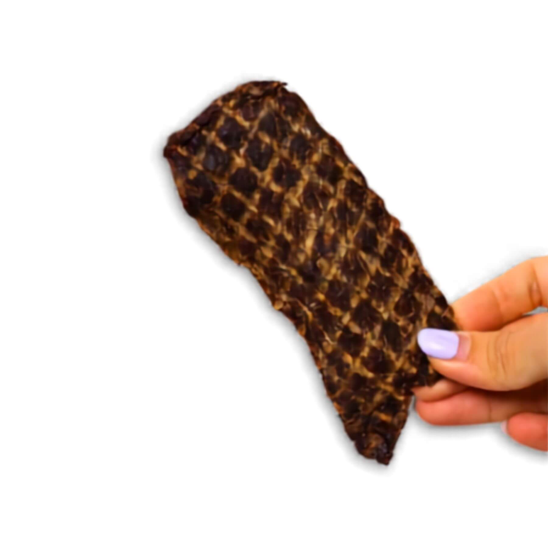 source-sage club ostrich jerky meat slice against a white background.