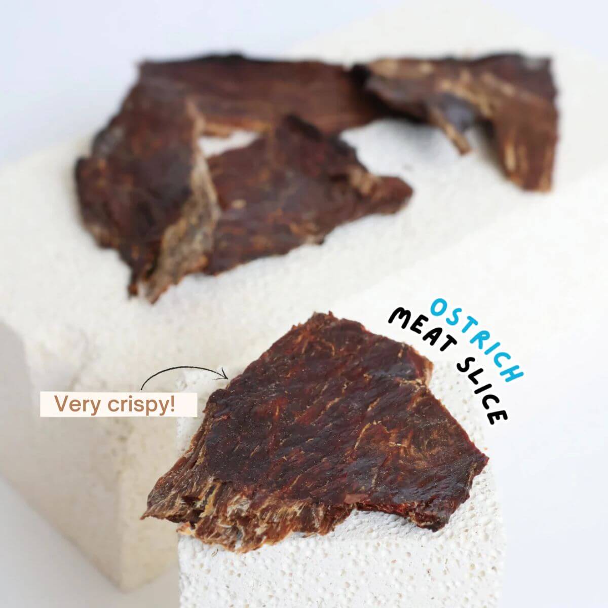 source-sage club ostrich jerky meat slice against a white background.