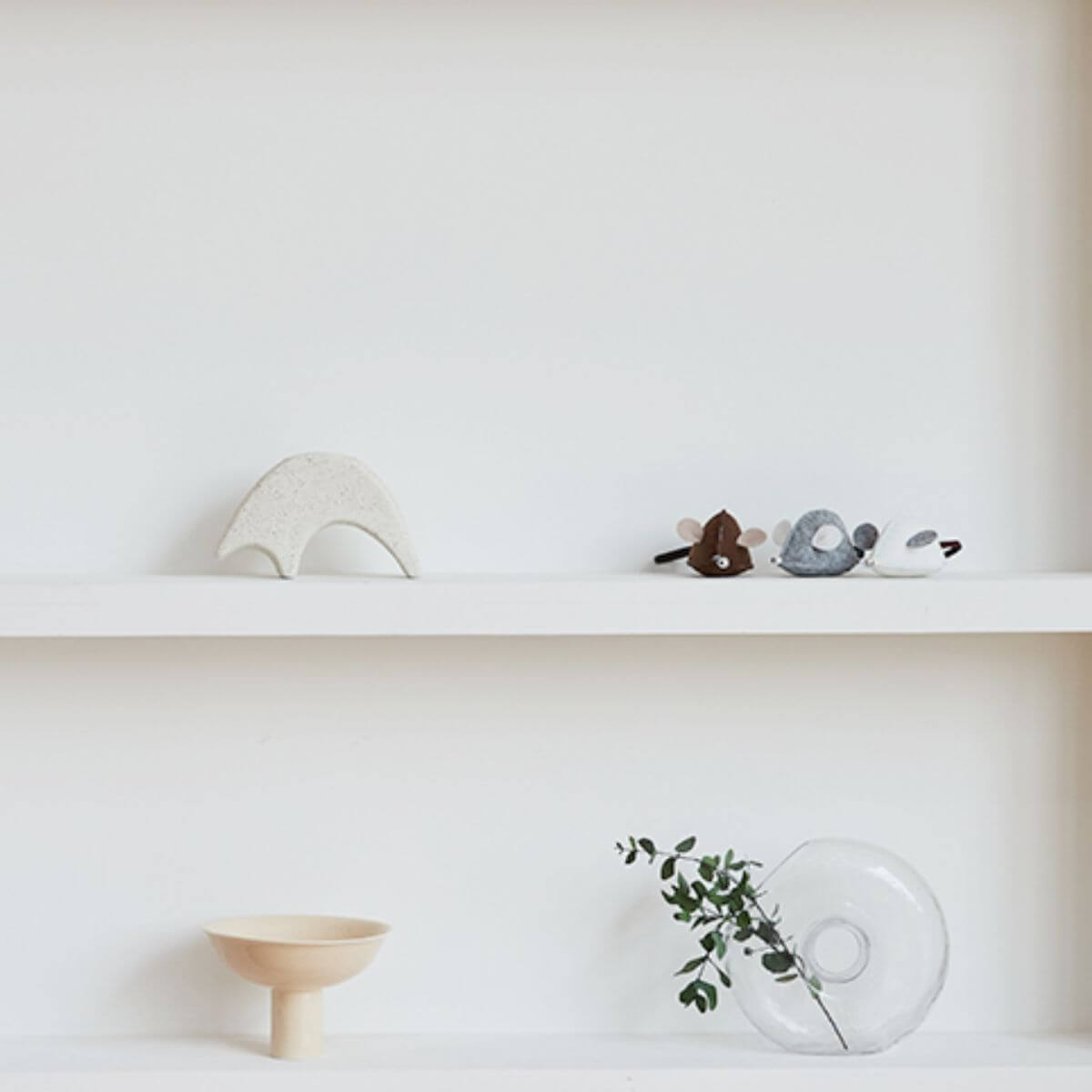 Studio Alive Mikitoy Catnip Mouse Toy on a living room display shelf.