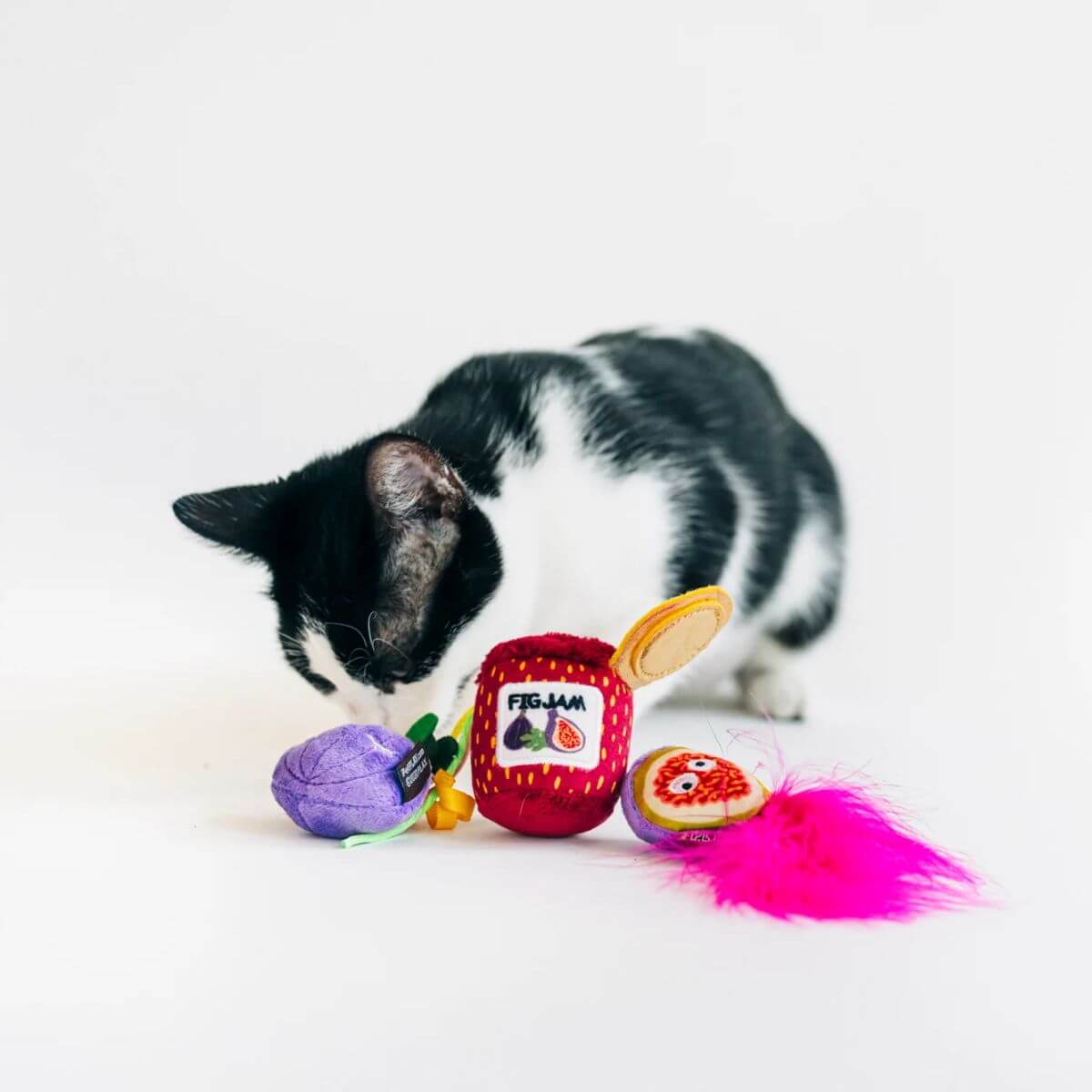 A cat playing with the PLAY Feline Frenzy Catnip Toy, Fig N' Whiskers.