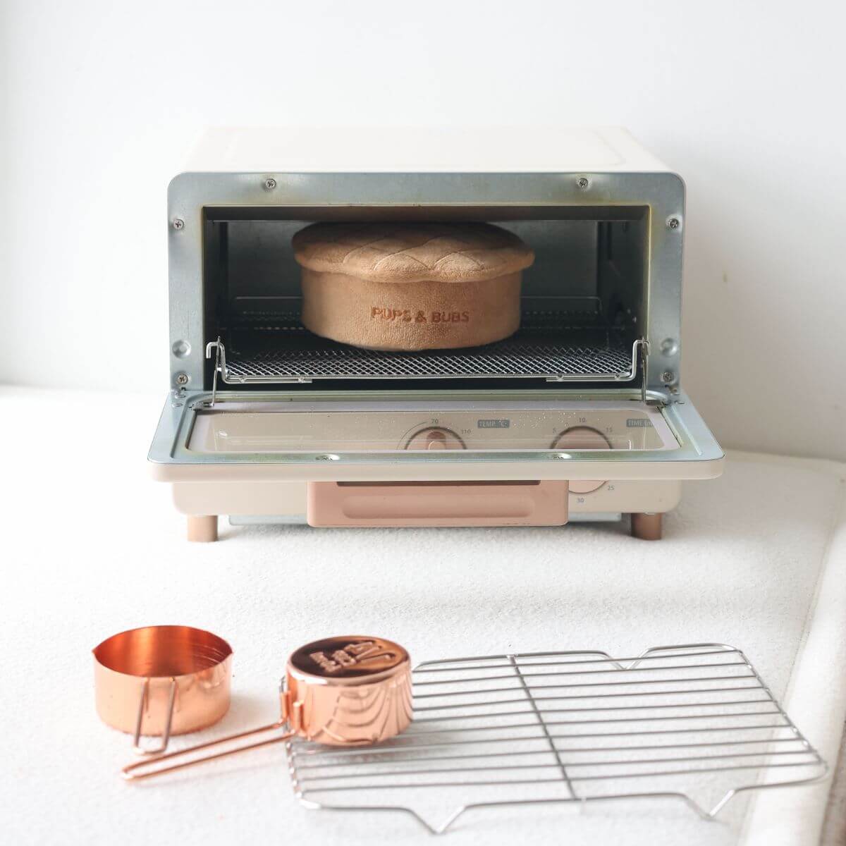 Pups and Bubs Apple Pie Nosework Toy in an oven. 