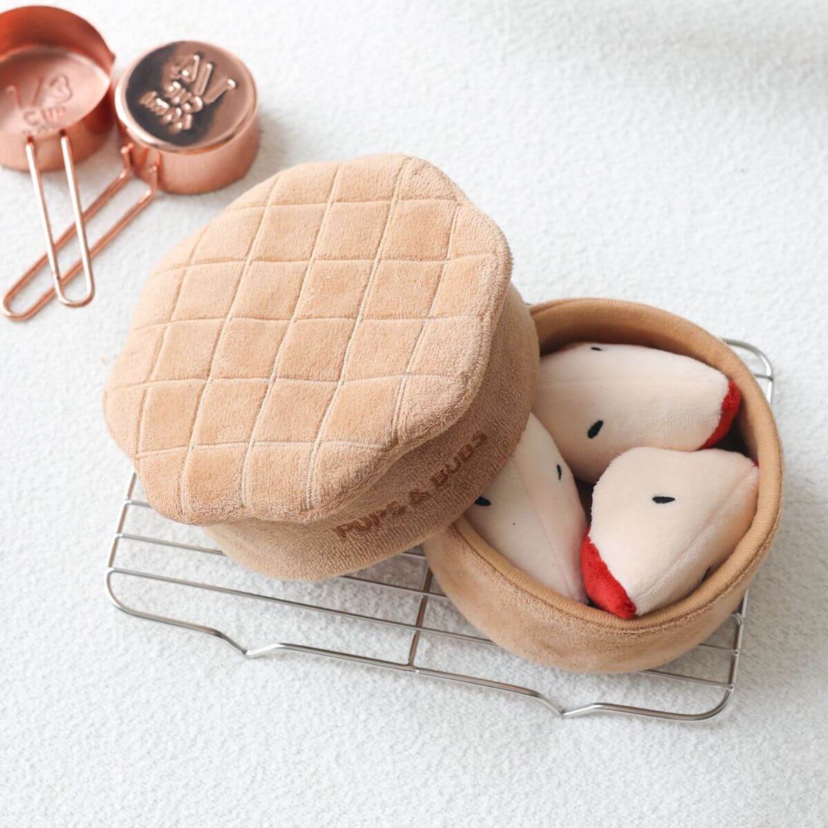 Pups and Bubs Apple Pie Nosework Toy on a rack. 