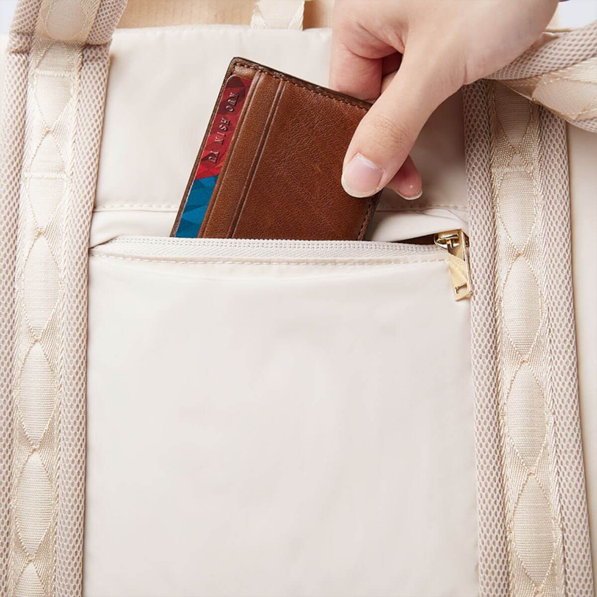 Pups and Bubs Everywhere Convertible Tote Bag Carrier in sand with a card holder in the back pocket. 