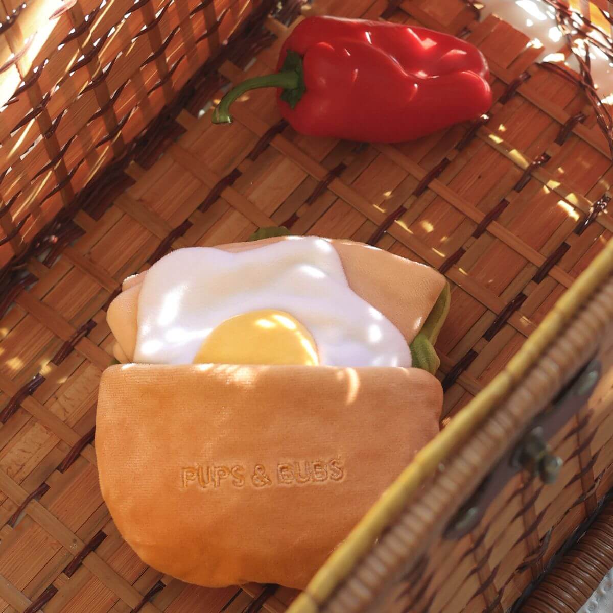 The Pups and Bubs Pita Pocket Nosework Toy in the picnic basket.