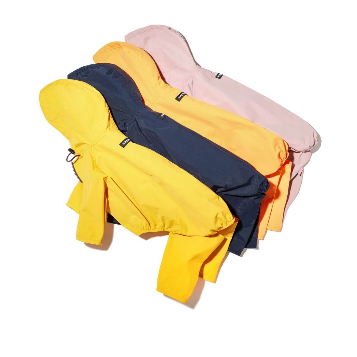 All the colours of the Wagwear Nylon Coverall Raincoat against a white background. 