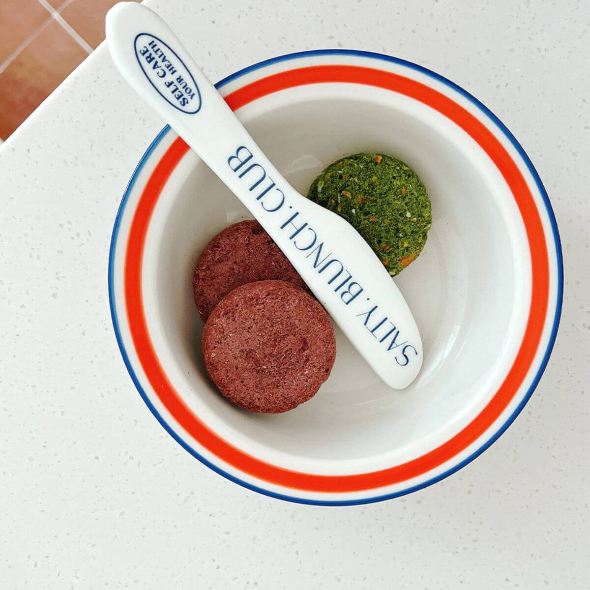 Arlo Kitchen Detox Purple Veggie Patties in a bowl, against a white background.