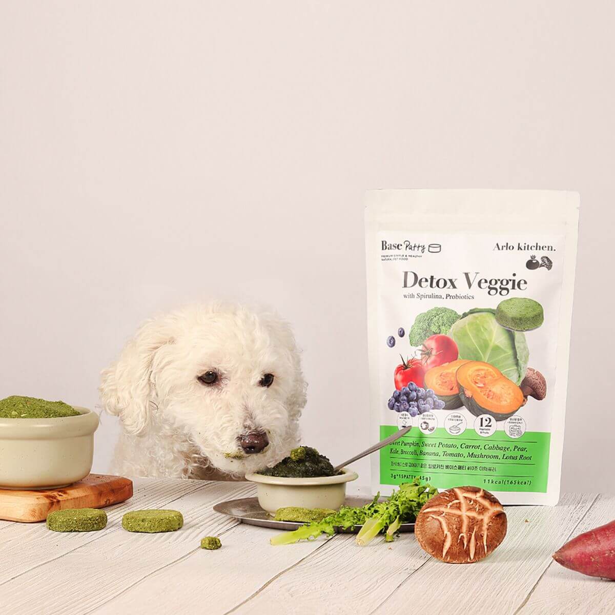 A poodle mix sniffing out the ingredients of the Arlo Kitchen Detox Veggie Patties.