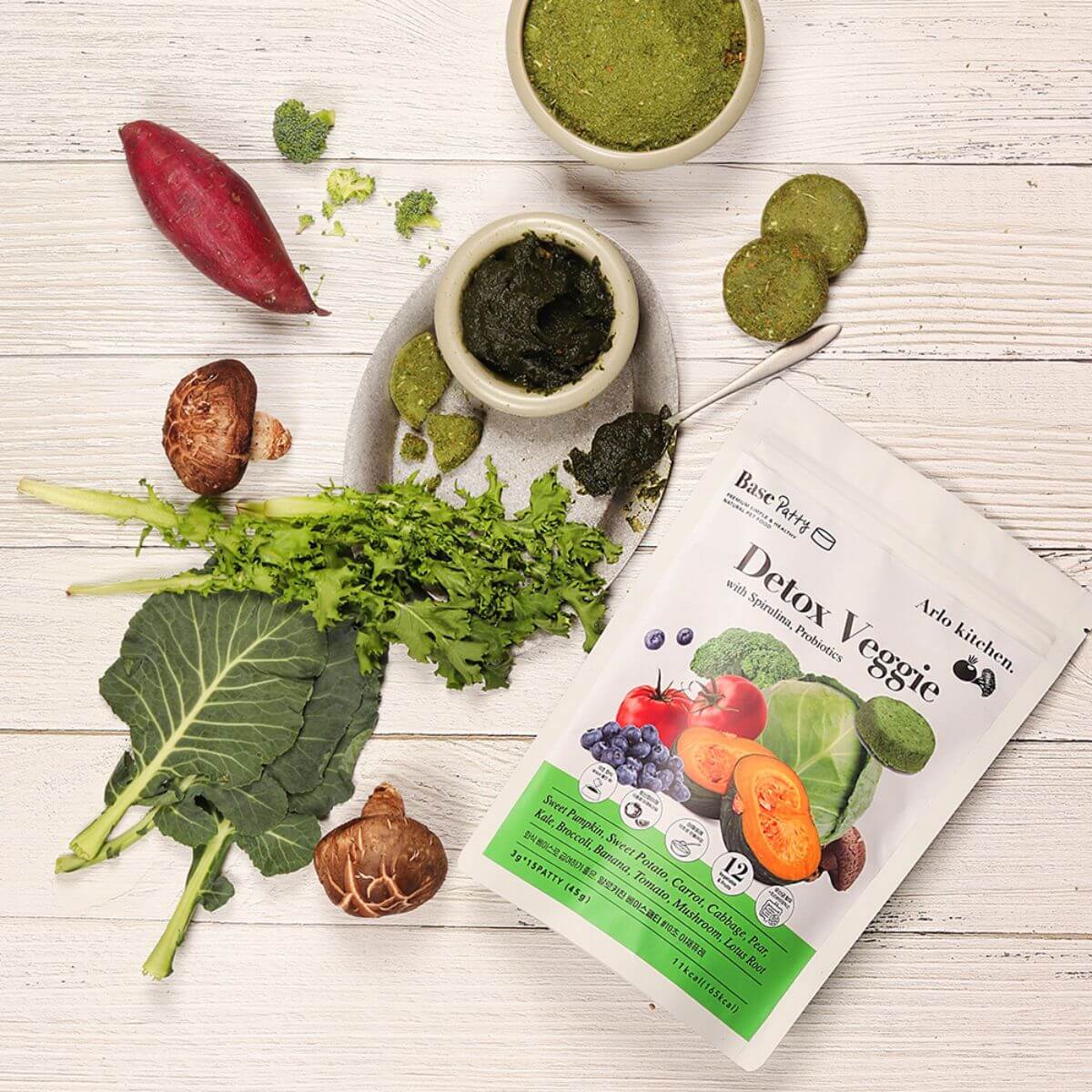 Arlo Kitchen Detox Veggie Patties and its ingredients around it.
