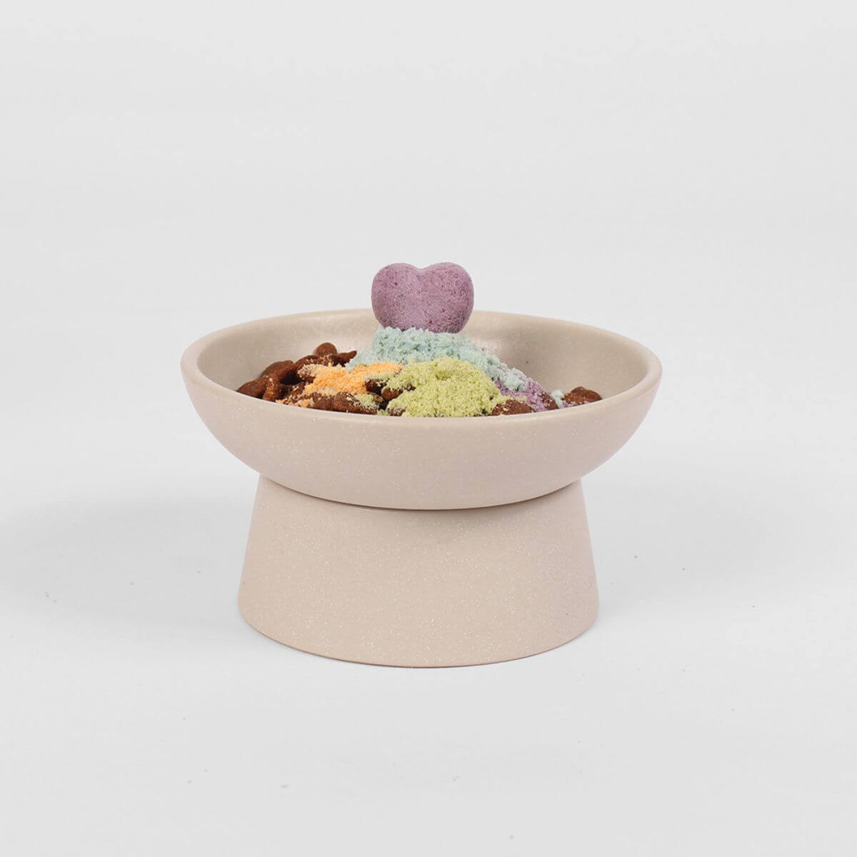 Arlo Kitchen Goat Milk Calming treats as a topper on top of food in a bowl.