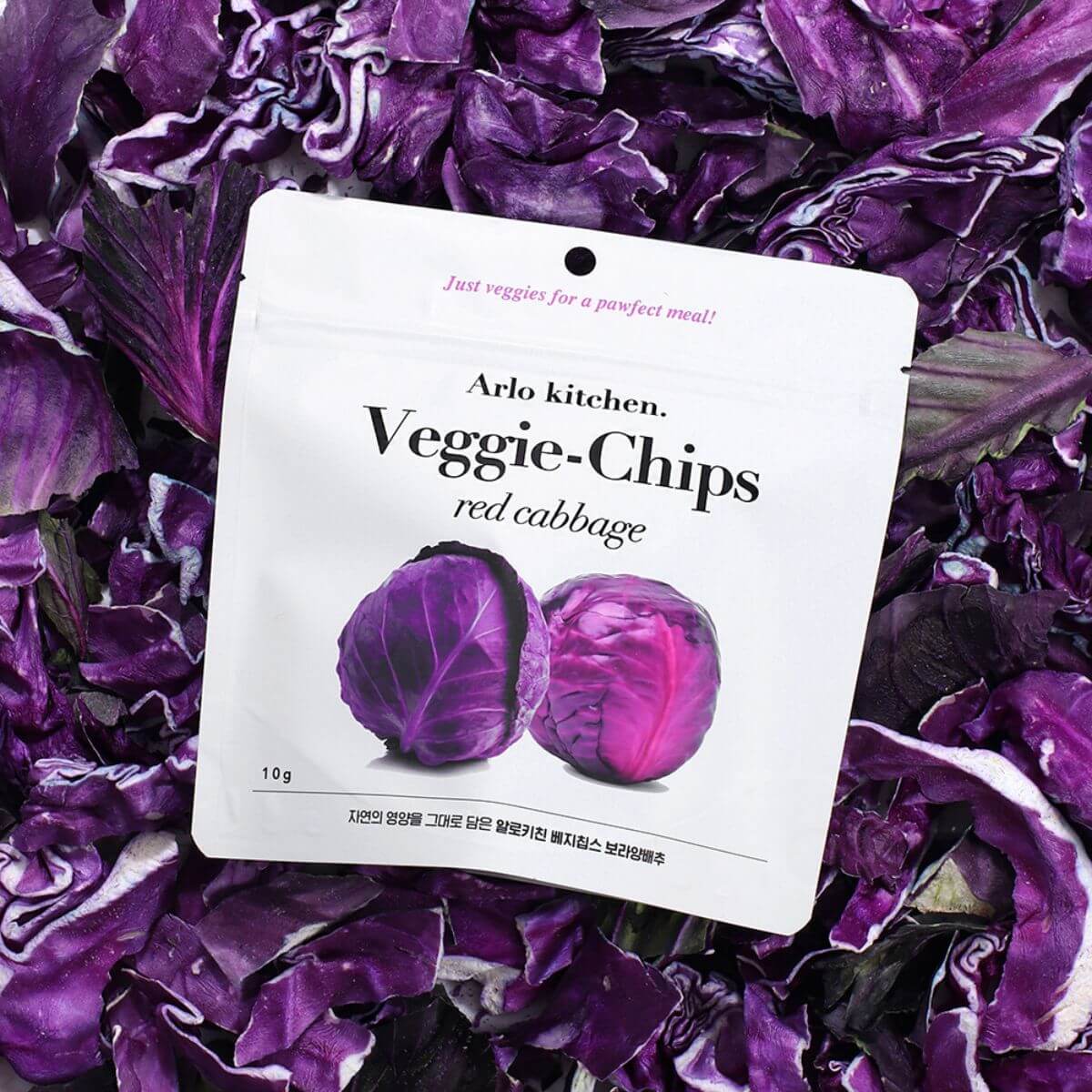 Arlo Kitchen Veggie Chips Red Cabbage against a bunch of red cabbage.