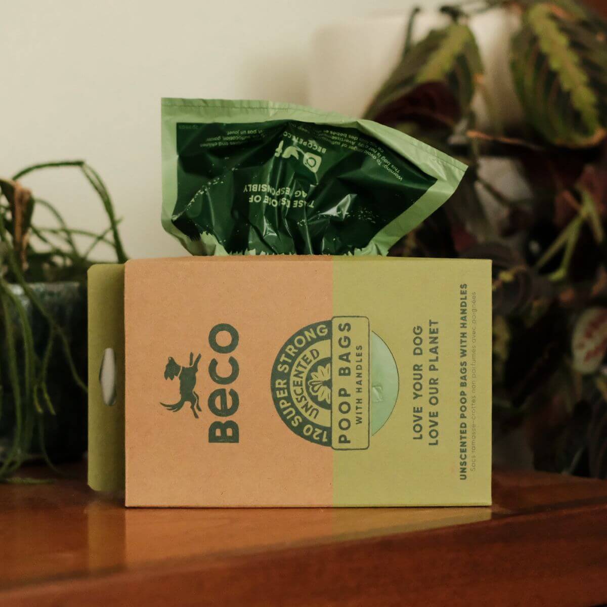 Beco Unscented Poop Bags with Handles displayed on a table that showcases the box dispenser.