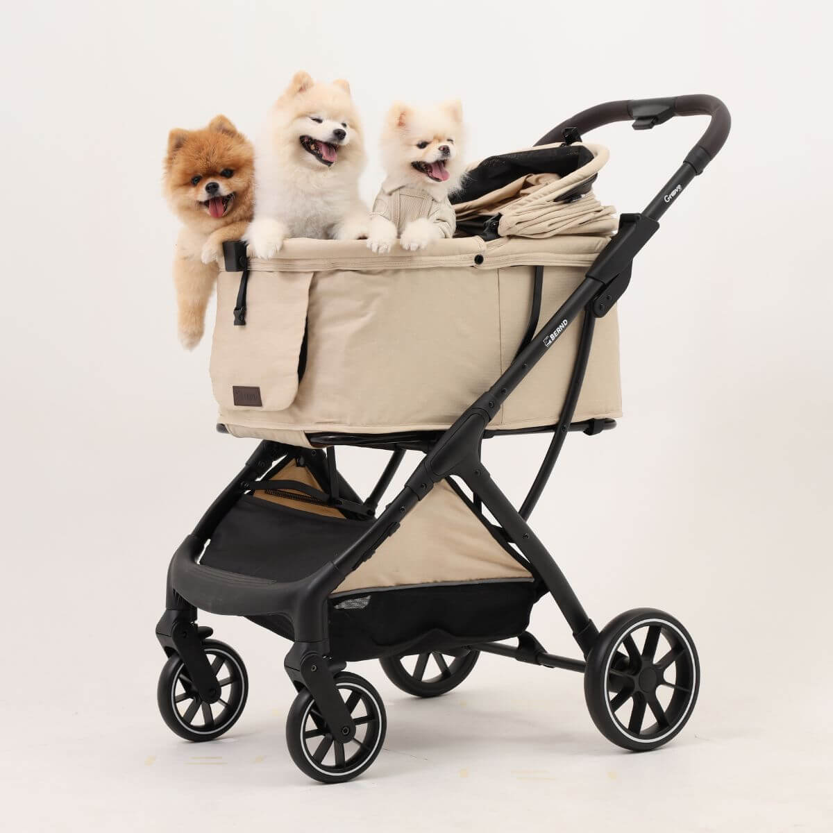 Bernd Pets Autofold Groove Pet Stroller in Latte Beige with 3 dogs in it.