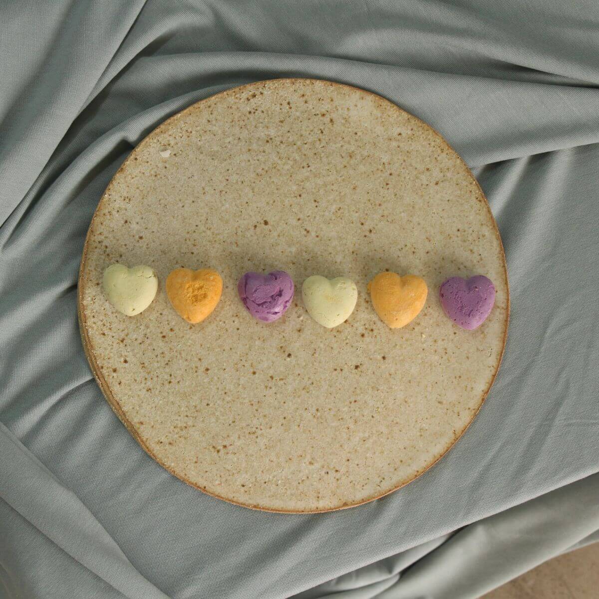 In Good Thyme Sweet Hearts Sweet Potato treats in a row on a plate.