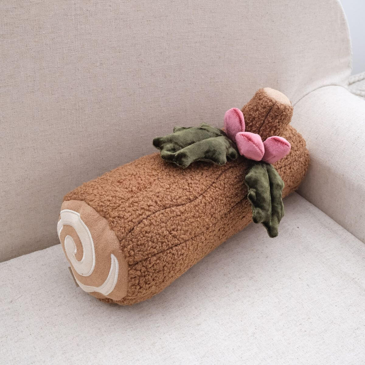 Lambwolf Yule Log Cake against a sofa background.