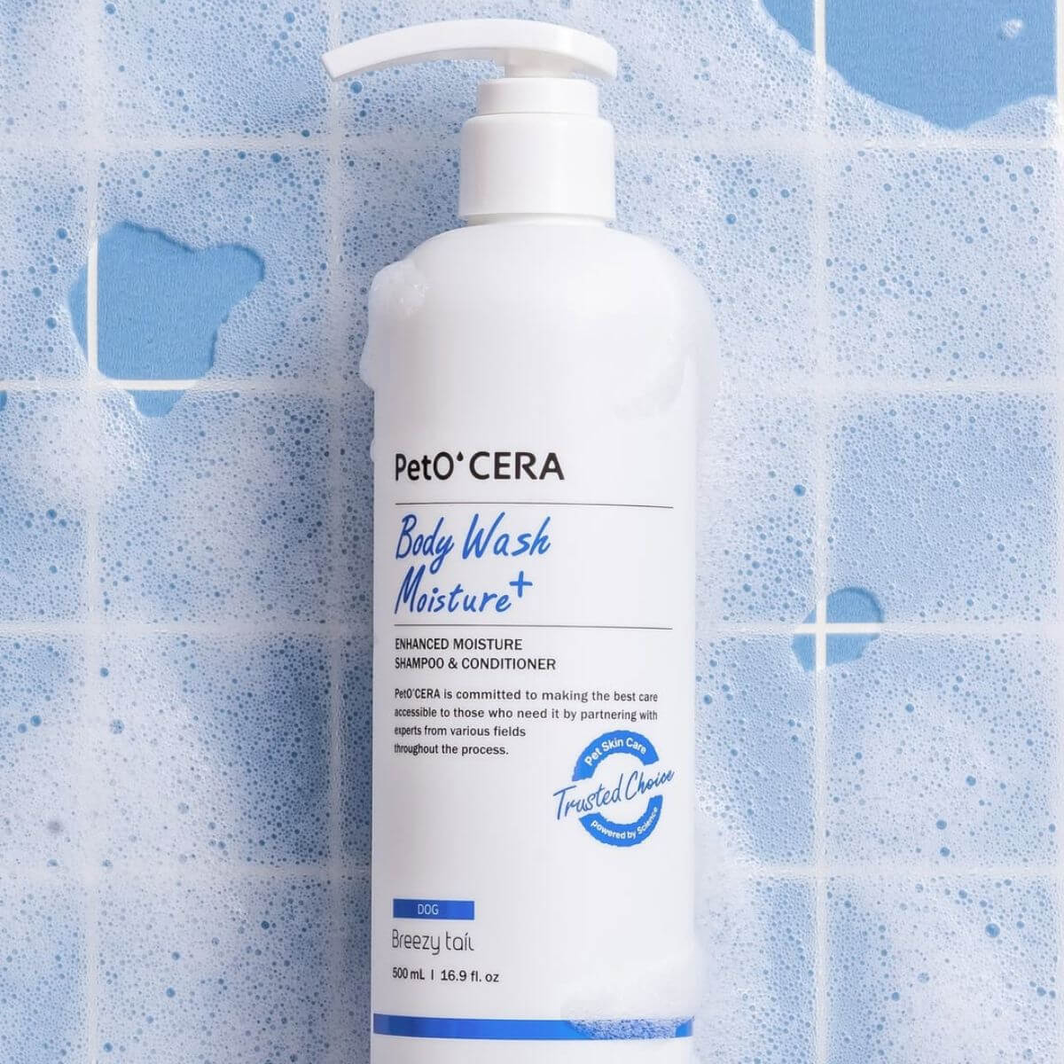 PetO'CERA Body Wash Moisture Plus against blue bathroom tiles with lather.