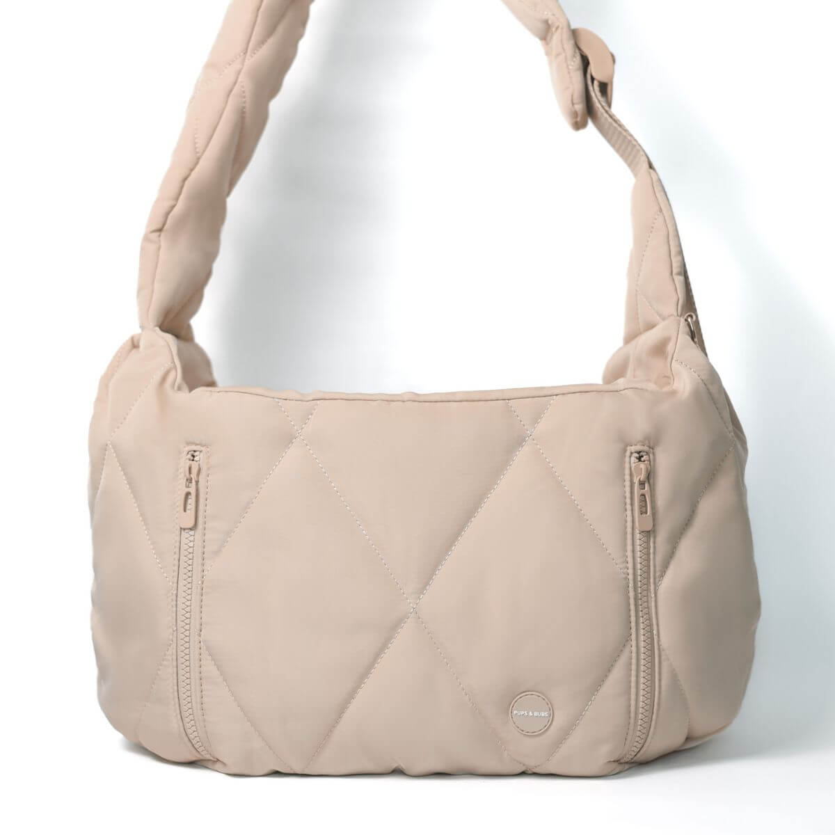 Pups & Bubs Cloud Crossbody Carrier in Latte against a white background.