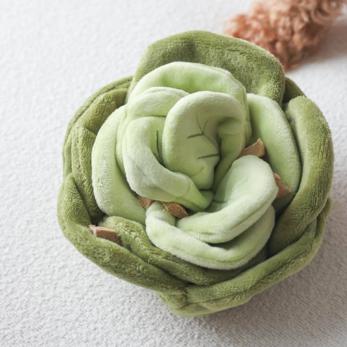 A close-up of the Pups & Bubs Snuffle Cabbage Nosework Toy.