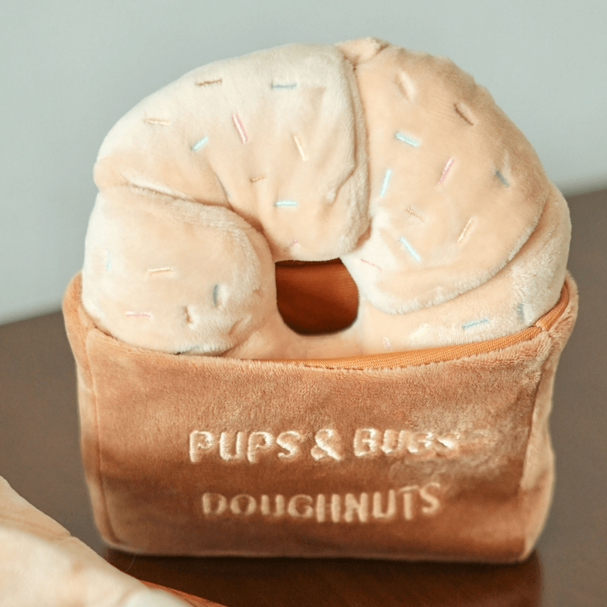 pups and bubs sprinkle donut nosework toy on a table.