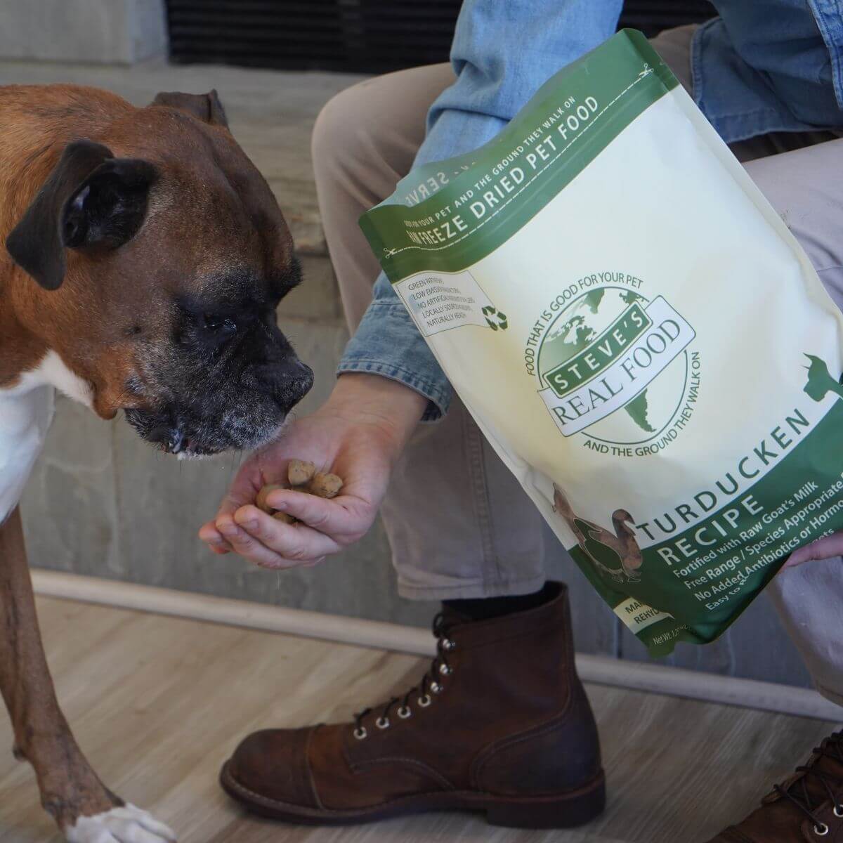 A mutt eating the Steve's Real Food Turducken Freeze Dried Nuggets against a kitchen background.