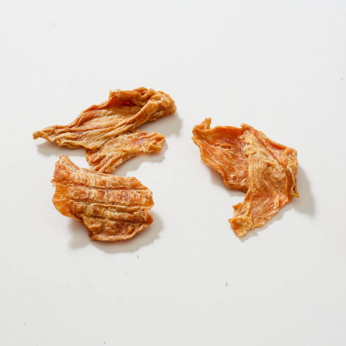 taki pets naaf chicken breast against a white background