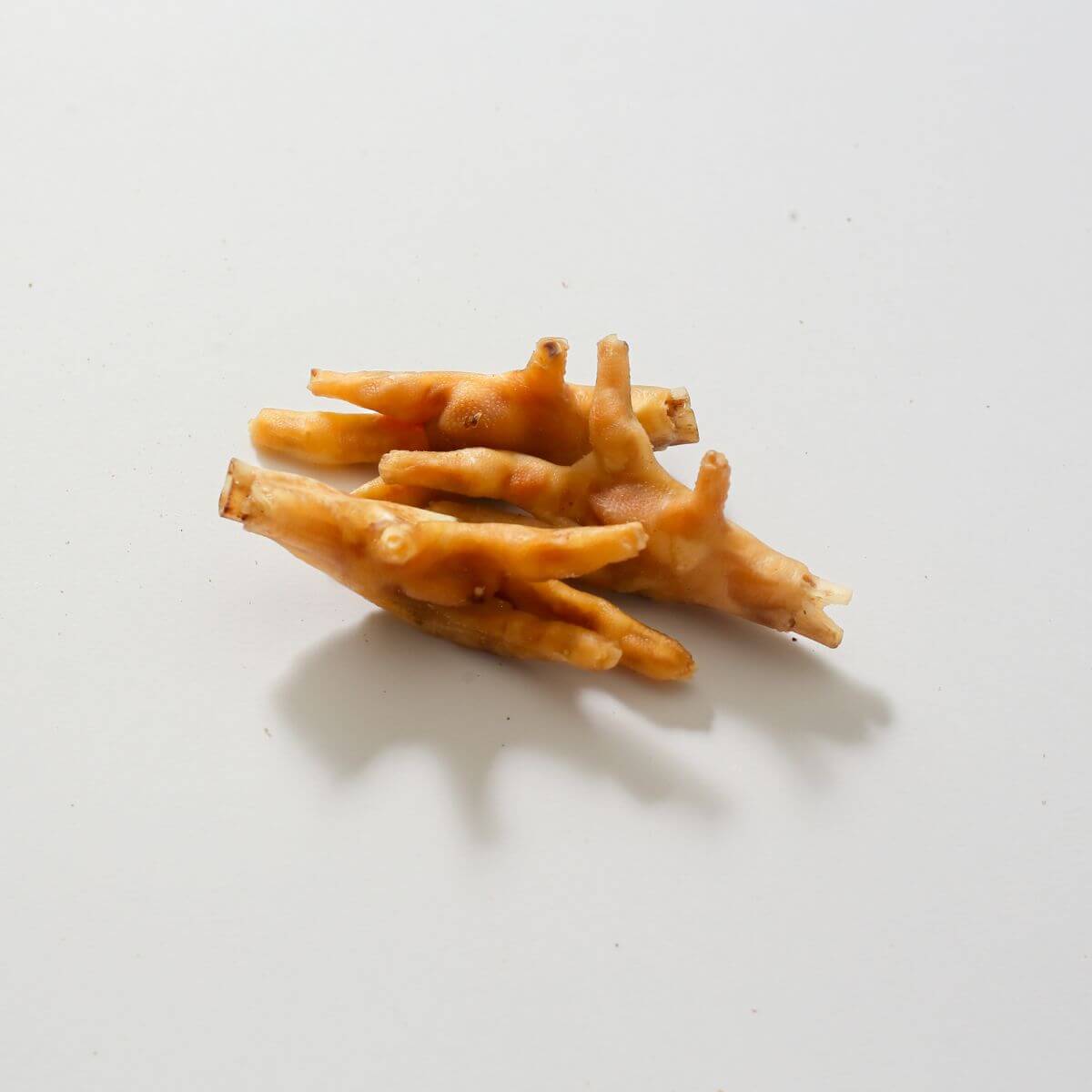 taki pets x naaf chicken feet against a white background.