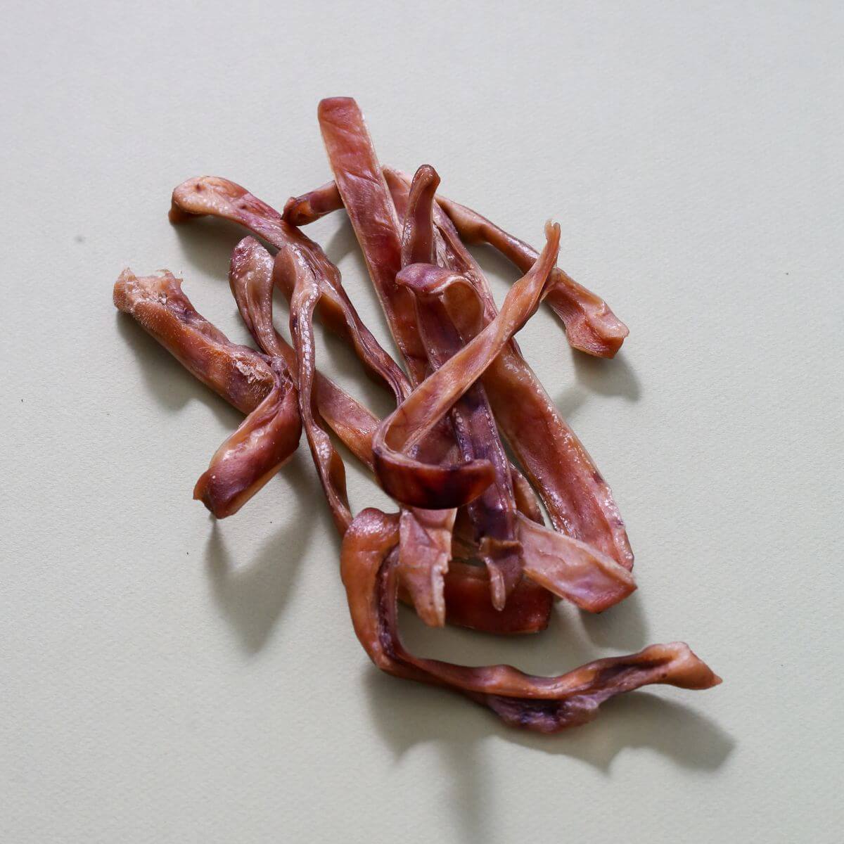 taki pets naaf pork ears against a white background.
