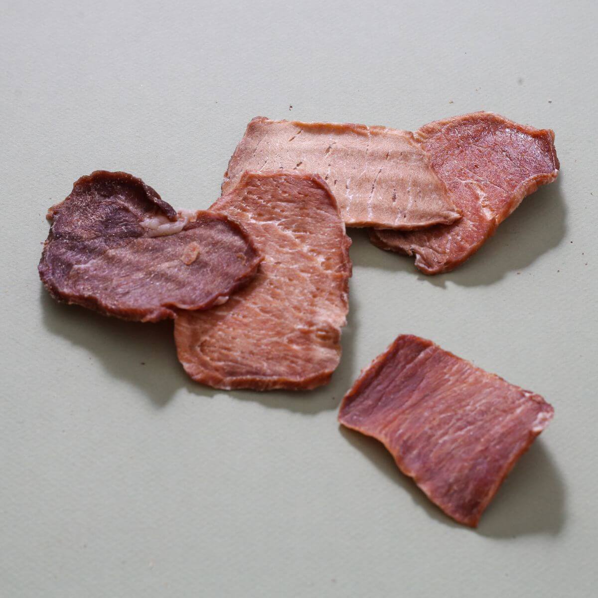 taki pets naaf pork lean meat against a grey background.