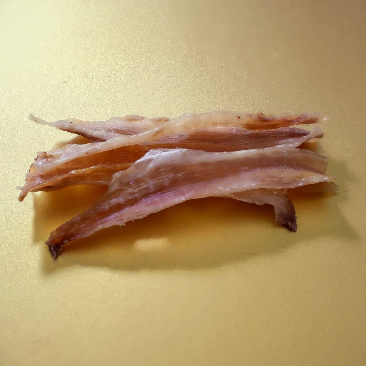 taki pets x naaf wagyu thigh tendon long against a yellow background.