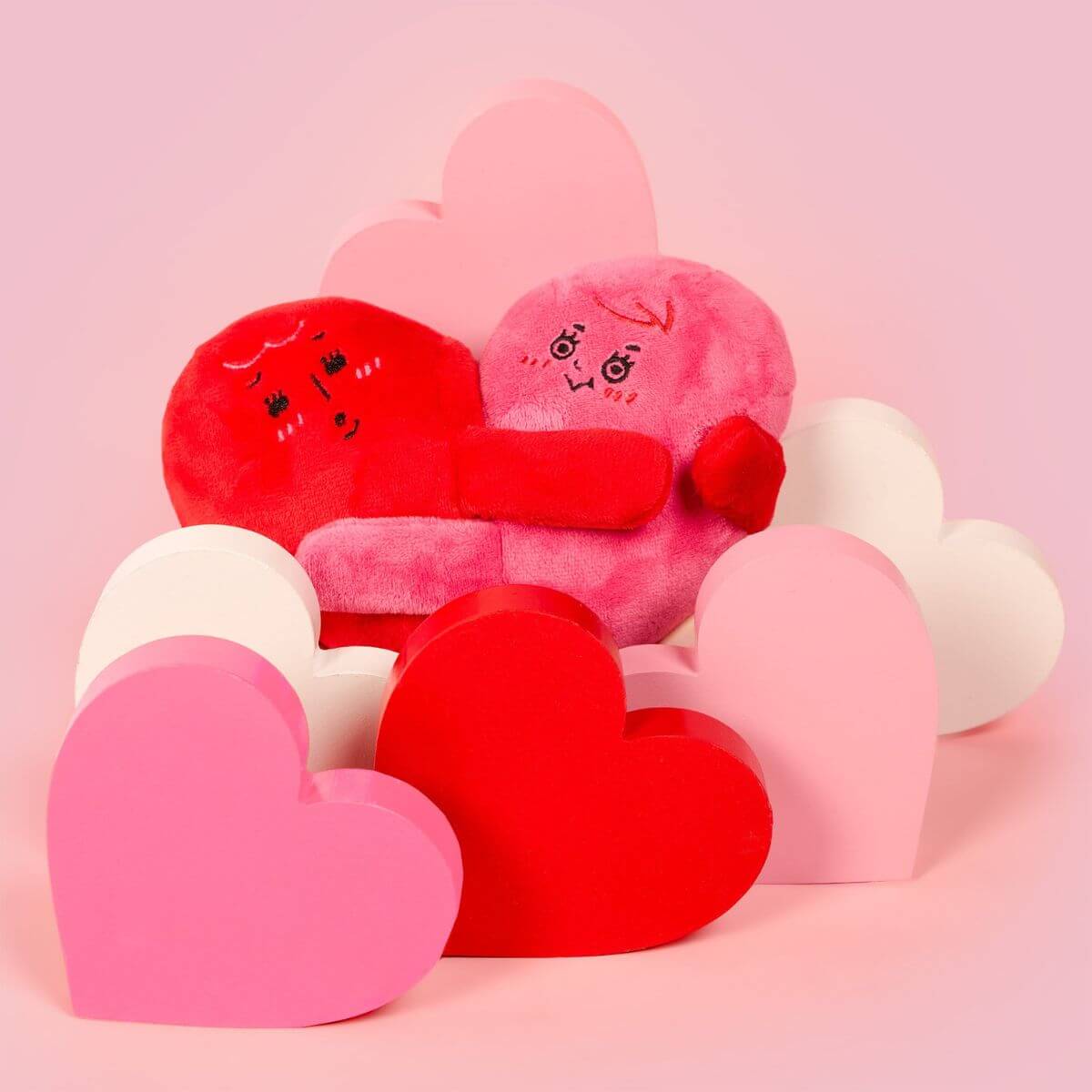 the furryfolks love locked nosework toy against a pink background surrounded with more heart displays.
