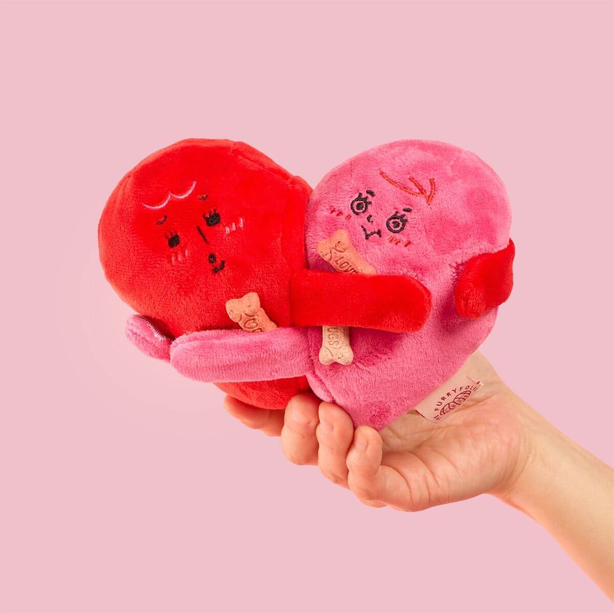 the furryfolks love locked nosework toy against a pink background.