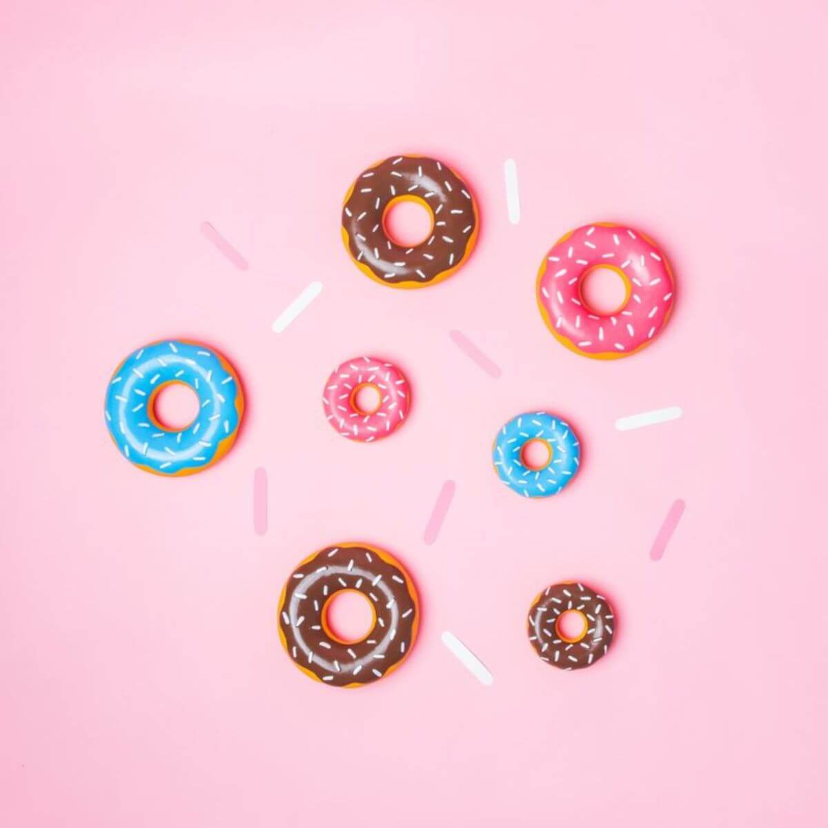 ZippyPaws Tuff Donutz series against a pink background.